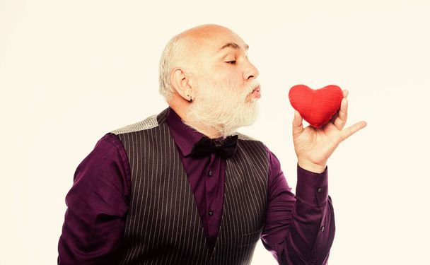 Preventing heart attack. Fall in love. Heartbeat diagnostics and treatment. Health care. Senior bald head bearded man hold red heart. Heart problem and healthcare. Mature man with valentines heart - Фото, изображение