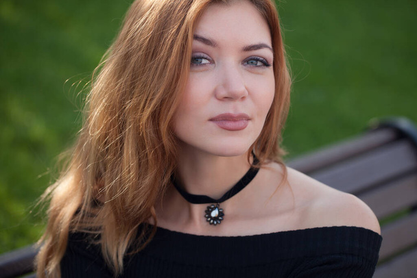 Girl with red hair in a black dress. - Fotografie, Obrázek