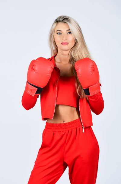 Overcome problems. Self improvement. Sporty girl red clothes boxing gloves. Gym and workout. Fitness model. Sporty lifestyle. Sporty woman fitness trainer. Personal training. Fight with own complex - Photo, image
