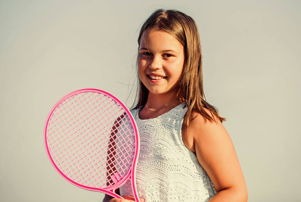 Sporty beauty. girl with tennis racquet. summer sport activity. energetic child. happy and cheerful. sporty game playing. summer outdoor games. play tennis. childhood happiness. healthy lifestyle - Fotó, kép