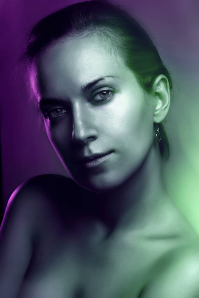 portrait of the naked beautiful girl. multicolor, mixed light image - Foto, imagen