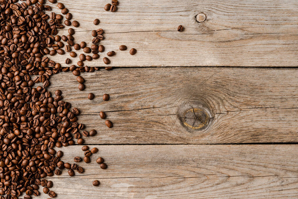 Coffee beans on an old wooden table. - Foto, afbeelding