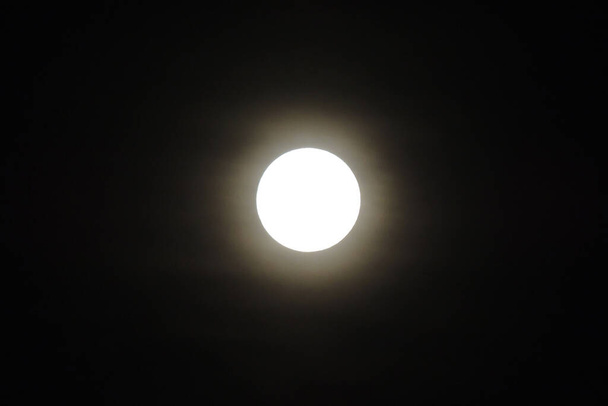 満月の終わりと黒い夜空に対する不気味な白い雲 - 写真・画像