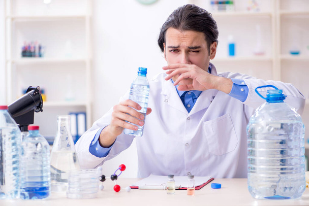 Young male chemist experimenting in lab - Zdjęcie, obraz