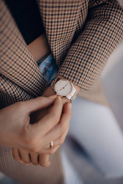 Stylish white watch on woman hand - Fotó, kép