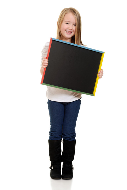 Cute little girl holding blackboard - Foto, Bild