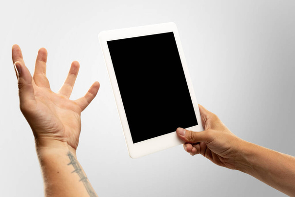 Close up male hands holding tablet with blank screen during online watching of popular sport matches and championships all around the world. Copyspace for ad - Фото, зображення