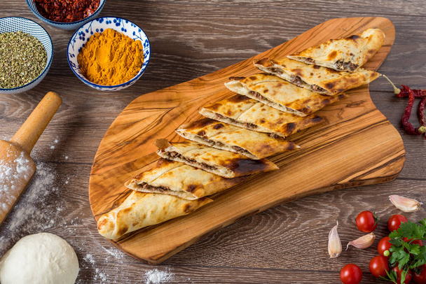 Traditional turkish baked dish pide. Turkish pizza pide, Middle eastern appetizers. Turkish cuisine. Top view. Pide with meat filling. - Photo, Image