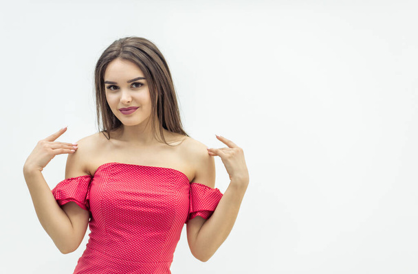 Young magnificent woman posing in trendy red dress over white background. - Photo, image