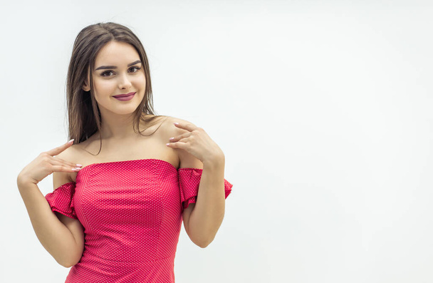 Young magnificent woman posing in trendy red dress over white background. - Foto, imagen