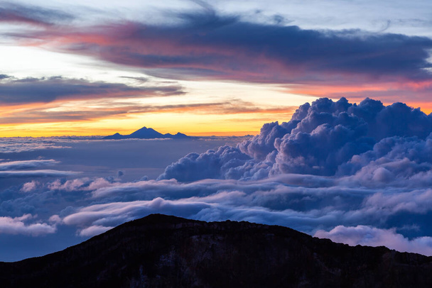 Amazing cloudscape with mt Rinjani at horizon View from mt Agung at sunrise Bali Indonesia - Foto, imagen