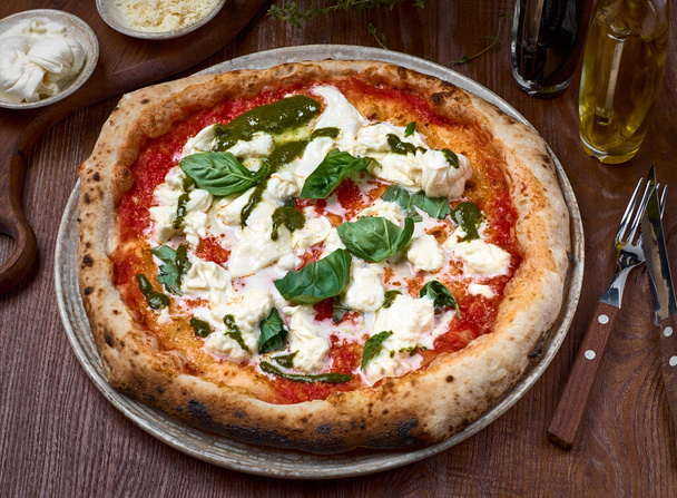 High Angle View of Pizza with tomatoes, basil and stracciatella. rome pizza on dark a wooden table. Healthy food. - Foto, Imagem
