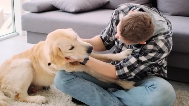 Cheerful man fooling with active dog - Filmagem, Vídeo