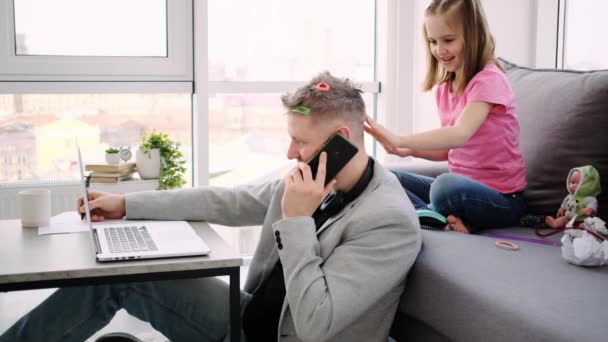 Lovely little girl combing busy father - Footage, Video