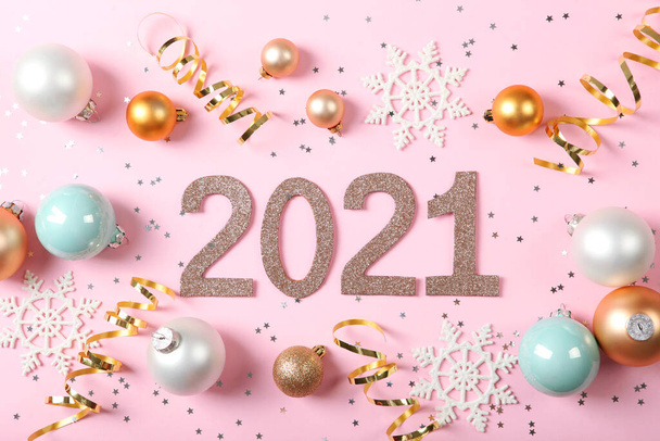 Composition with numbers 2021 and Christmas decor on a colored background top view - Photo, Image