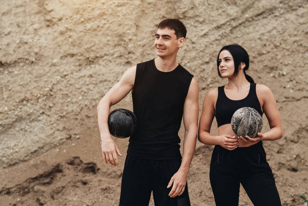Two Athletes Wearing Black Sportswear Open Air Healthy Lifestyle and Outdoor Training Concept - Фото, изображение
