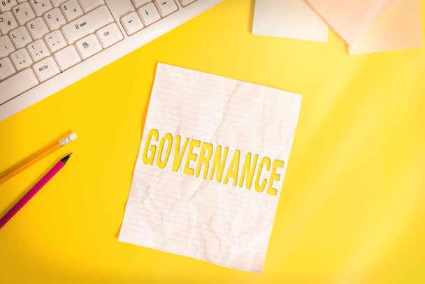 Word writing text Governance. Business concept for exercised in handling an economic situation in a nation Copy space on notebook above yellow background with pc keyboard on the table. - Photo, Image