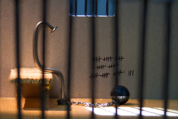 Conceptual jail photo with iron nail ball and chain - Photo, image