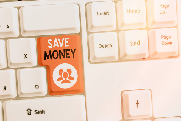 Text sign showing Save Money. Conceptual photo to budget or put money aside for the future or emergency Different colored keyboard key with accessories arranged on empty copy space. - Photo, Image