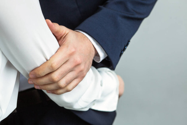 Caucasian business people, man and woman touch and hug each other. Love affair at office workplace concept. Close up of human hands in motion - Zdjęcie, obraz