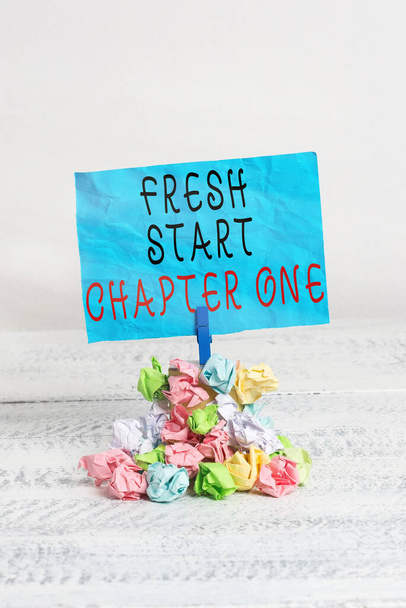 Conceptual hand writing showing Fresh Start Chapter One. Business photo showcasing changes in your circumstances new career and chances Reminder pile colored crumpled paper clothespin wooden space. - Photo, Image