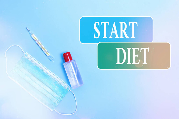 Writing note showing Start Diet. Business photo showcasing the practice of eating food in a regulated and supervised fashion Primary medical precautionary equipments for health care protection. - Photo, Image