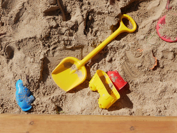 Kinderspeelgoed verspreid in de zandbak. Hoge kwaliteit foto - Foto, afbeelding
