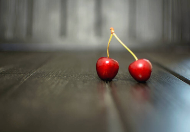 Ripe sweet cherries on a wooden background - Фото, зображення