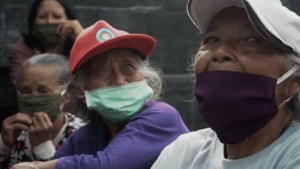 Benoa, Kuta, Kabupaten Badung, Bali, Indonesia - July 8, 2020: Video of a small village in Indonesia with masked old people on their faces - Кадри, відео
