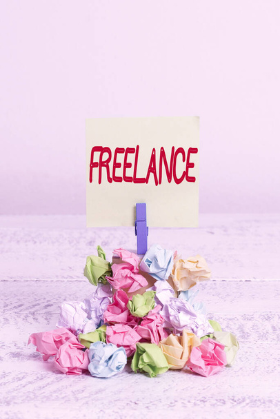 Word writing text Freelance. Business concept for working at different firms rather than being permanently Reminder pile colored crumpled paper clothespin reminder white wooden space. - Foto, Imagem