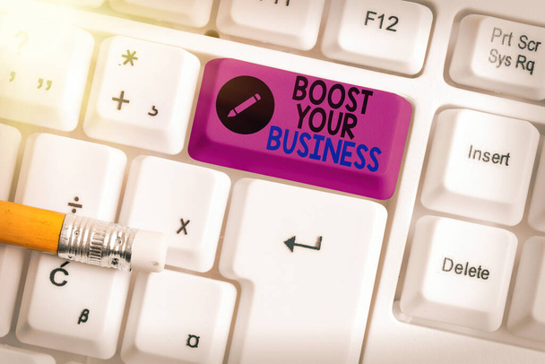 Conceptual hand writing showing Boost Your Business. Business photo showcasing Suitable for web Landing page, web page design to increase profit Colored keyboard key with accessories arranged on copy - Foto, afbeelding