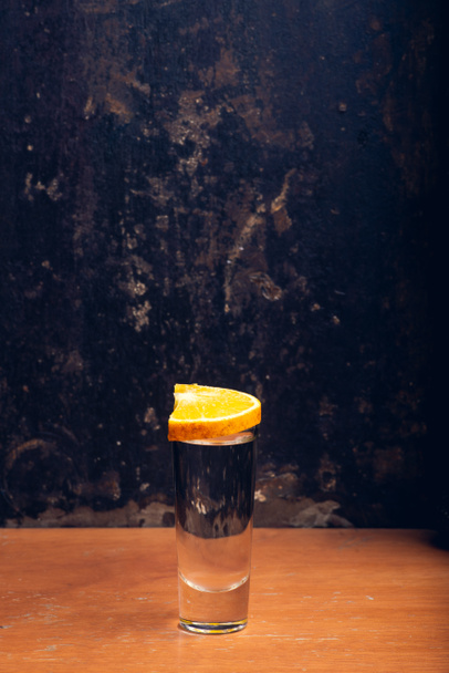 Mezcal shot on rustic background with space for text. Vertical shot - 写真・画像