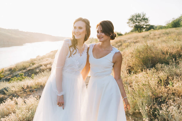 lesbisch bruiloft paar in wit jurken - Foto, afbeelding