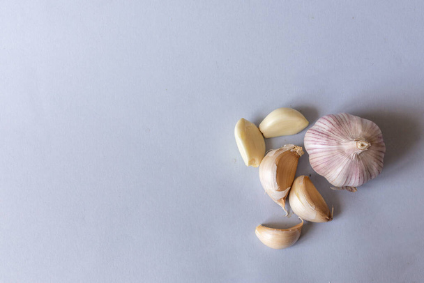 garlic lies on a gray background. Photographed at close range.  - Fotó, kép