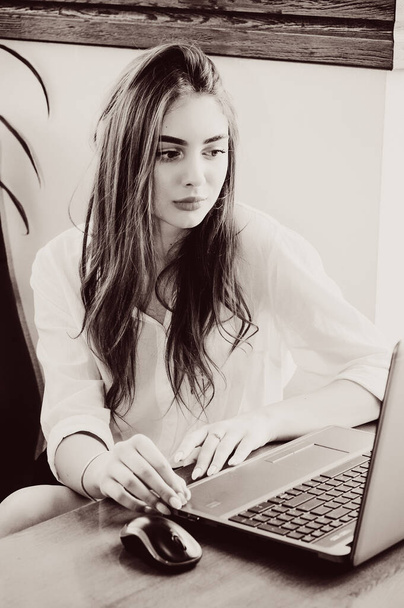 Молода красива бізнес-леді працює на ноутбуці. Красива дівчина в білій сорочці за комп'ютером. бізнес-леді економіст в формальному носінні концентрований, перед ноутбуком, стильний, міркувати, серйозний
 - Фото, зображення