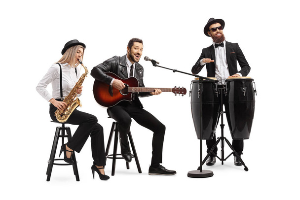 Man playing an acoustic guitar, female sax player and a man conga drummer performing in a band isolated on white background - Фото, изображение