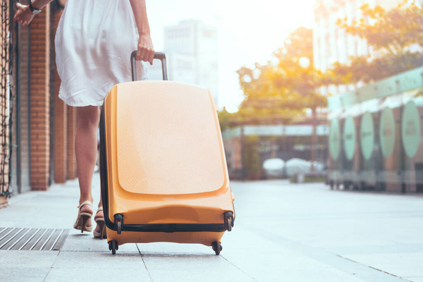 girl traveler and her yellow  luggage. wonderful trave - Valokuva, kuva