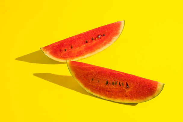 Fresh ripe watermelon slices on yellow background. - Foto, afbeelding