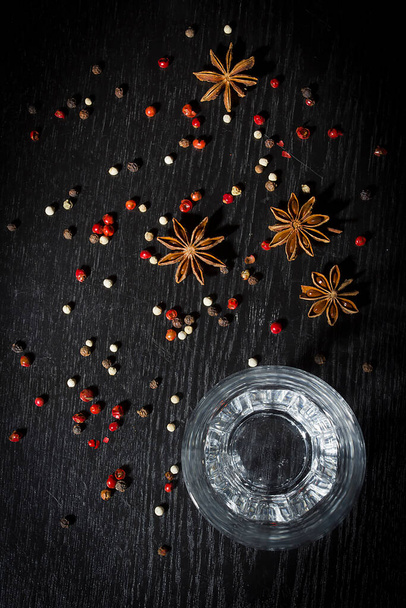 Anise vodka in a glass on a wooden surface - Foto, immagini