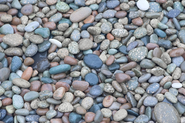 4 - Hundreds of bright wed red and blue colored pebbles create a simple and relaxing background. Smooth stones found on a beach. - Photo, Image