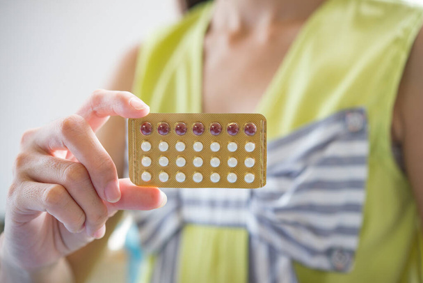 Mujer mano sosteniendo un panel anticonceptivo prevenir el embarazo
 - Foto, imagen
