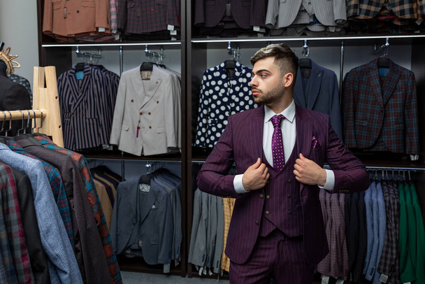 sale, fashion, retail, business style and people concept - seriously hipster man with beard at clothing store. Advertising photo. Perfect to last detail. Model suit. Man in suit. - Photo, Image