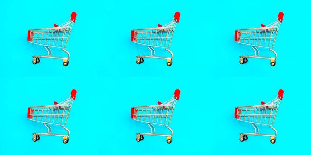Basket on a blue background. Shopping cart in a supermarket. Sale, discount, shopaholism. Creative design. Banner. - Photo, Image