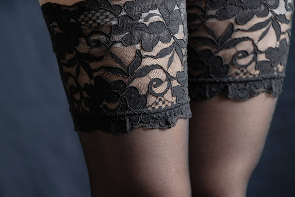 female legs in stockings with lace on an isolated background - Photo, Image