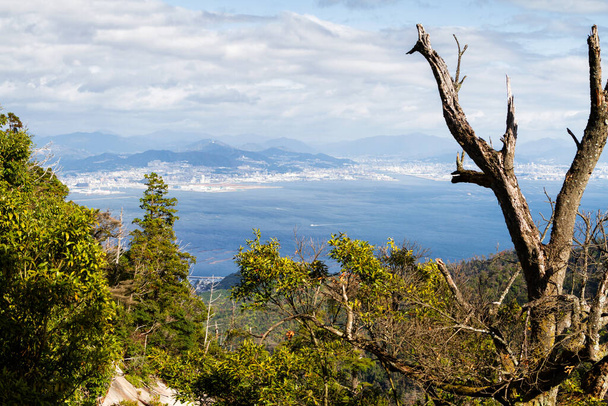 Panorama of Miyajima island seen from the mountains. Miyajima with its Itsukushima Jinja shrine is a popular tourist destination near Hiroshima, Japan - Foto, Imagem