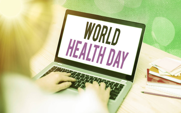 Writing note showing World Health Day. Business photo showcasing global health awareness day celebrated every year on 7 April Modern gadgets white screen under colorful bokeh background. - Photo, Image