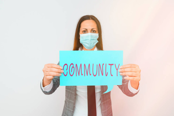 Conceptual hand writing showing Community. Business photo text group of showing with a common characteristics living together Promoting health awareness with precautionary medical equipment. - Photo, Image