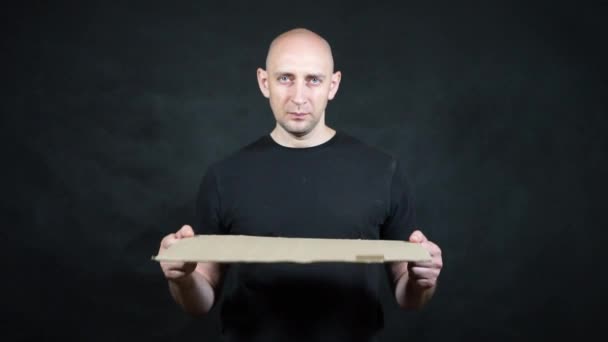 A bald European man in a black T-shirt. - Filmati, video