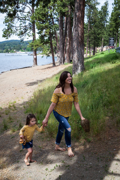 Mother and daughter with matching outfits spending the day at the beach in Coeur d' Alene Idaho - Photo, Image
