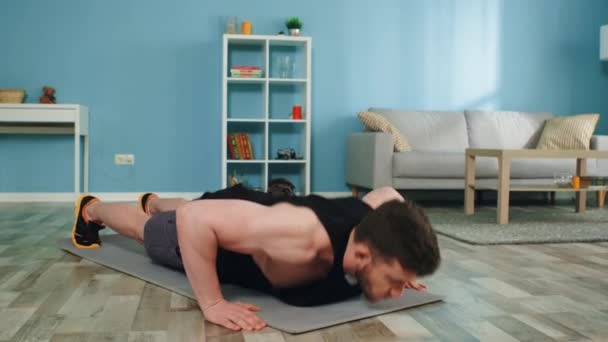 Young Man Is Doing Push-Ups at Home - Кадры, видео